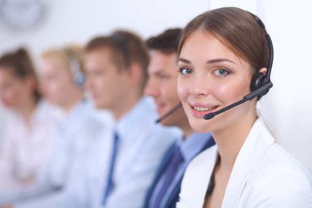 Attractive positive young businesspeople and colleagues in a call center office - Fotó, kép