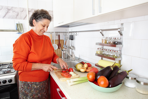 Senior woman in the kitchen - Photo, image