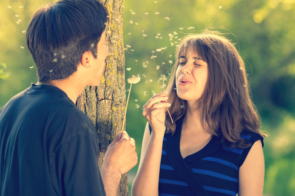 boy and girl blowing dandelions and laughing - Foto, Imagem