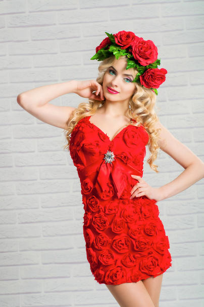 Beautiful girl with blond long hair in a red dress and a wreath - Φωτογραφία, εικόνα
