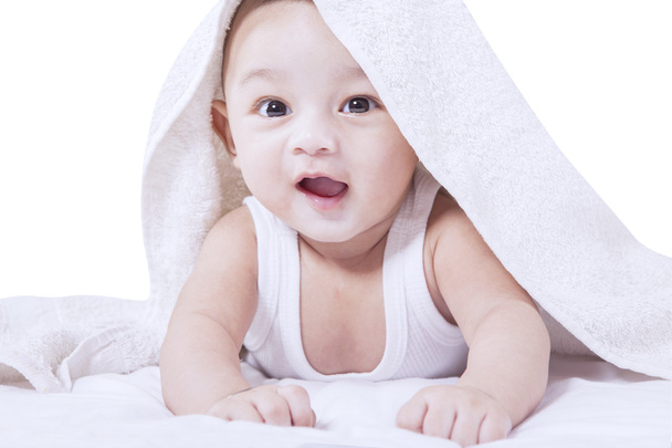 Male toddler smiling at camera on bed - Foto, Imagem