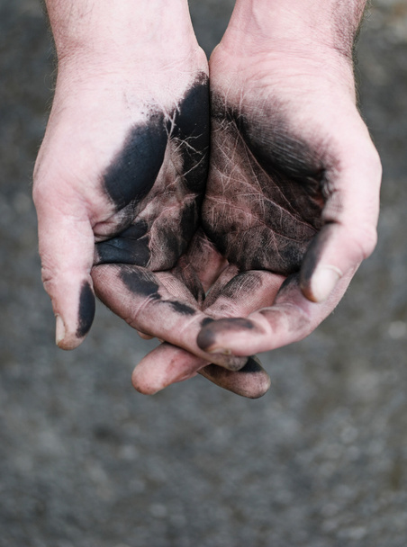 Empty cupped hands dirty of charcoal - 写真・画像