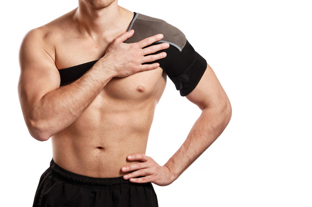 Sportsman with a support bandage on his shoulder - Foto, Imagen