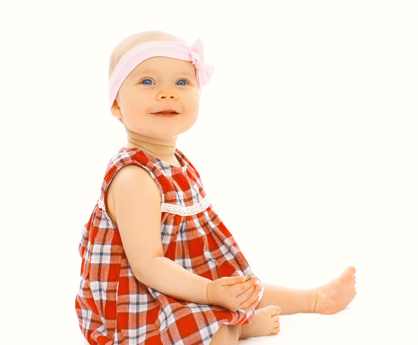 Portrait of cute little baby girl in the dress sitting on a whit - Foto, Imagem