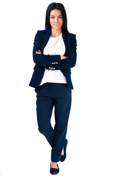 Smiling businesswoman standing with arms folded  - Фото, изображение