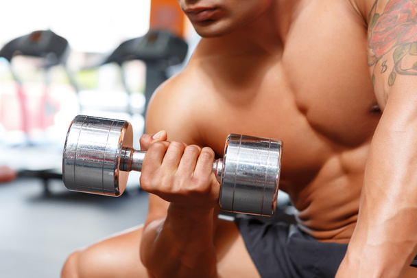 Power lifter working out with dumbbells in gym - Photo, Image