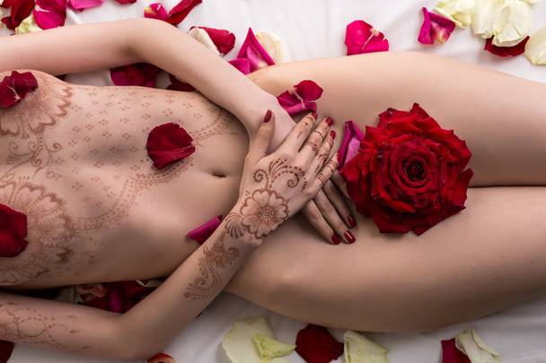 Top view of nude female body with mehendi pattern - Foto, imagen