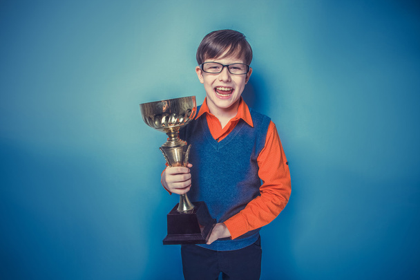 European-looking  boy of  ten years  in glasses holding a cup, a - 写真・画像