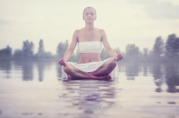young woman relaxes sitting on  water  - Photo, Image