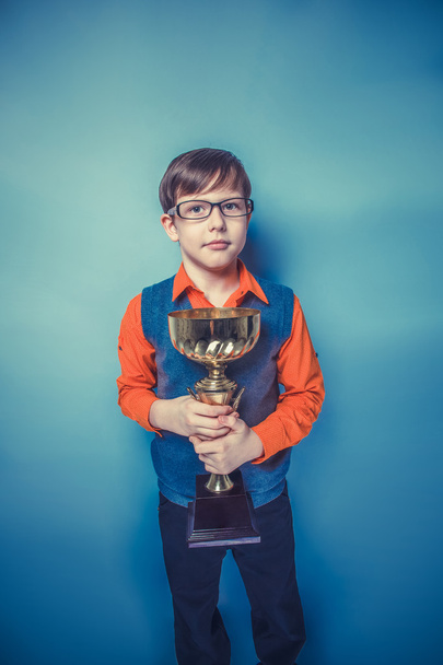 European-looking  boy of ten years in glasses holding a cup, awa - 写真・画像