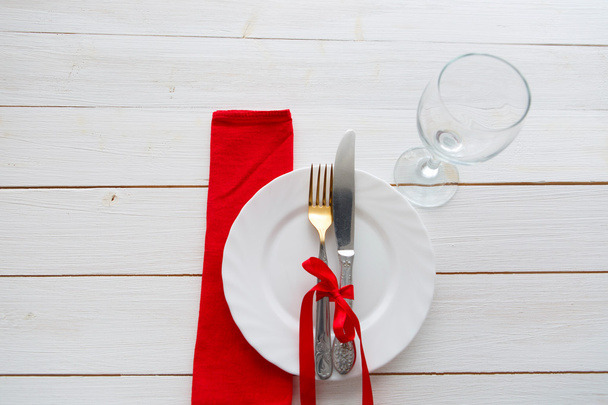 Knife, fork and dish over wooden table - Fotó, kép