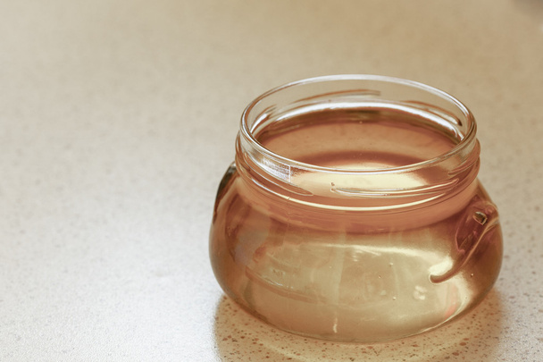 Jar of organic floral honey or syrup - Foto, Bild