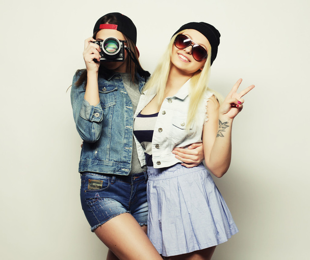 Two girls with cameras in hipster style - Fotó, kép