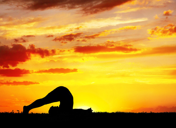 Yoga silhouette Halasana plough pose - Photo, Image