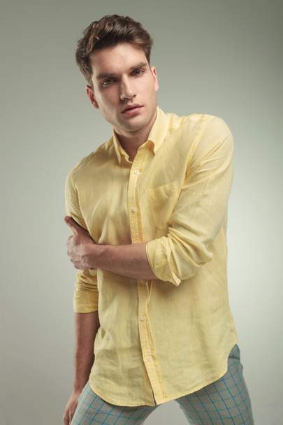 Young casual fashion man holding his right arm - Photo, Image