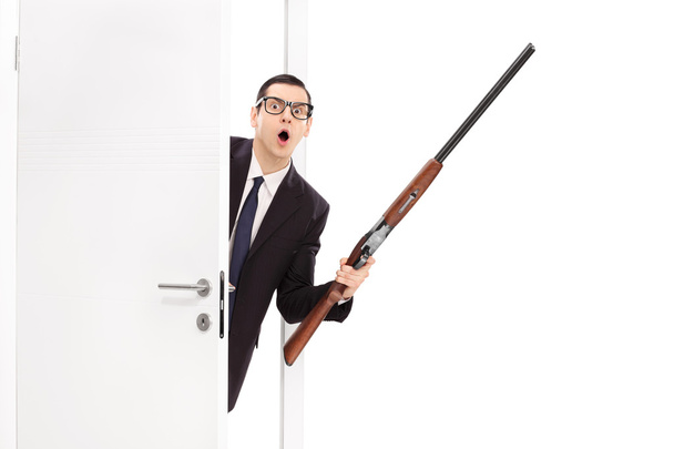 Angry businessman holding a shotgun rifle - Foto, Imagem