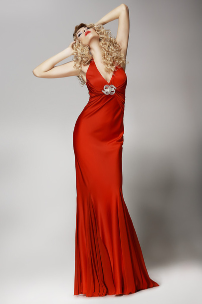 Seductive Shapely Woman in Red Dress posing - 写真・画像