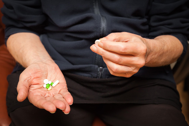 old man's palm with pills - 写真・画像