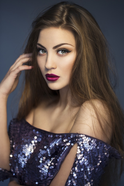 Sexy Beauty Girl with purple-red Lips. Provocative Make up. Luxury Woman with Green Eyes. Fashion Brunette Portrait wearing in dress with sparkles. Gorgeous Woman Face. Long Hair - Photo, Image