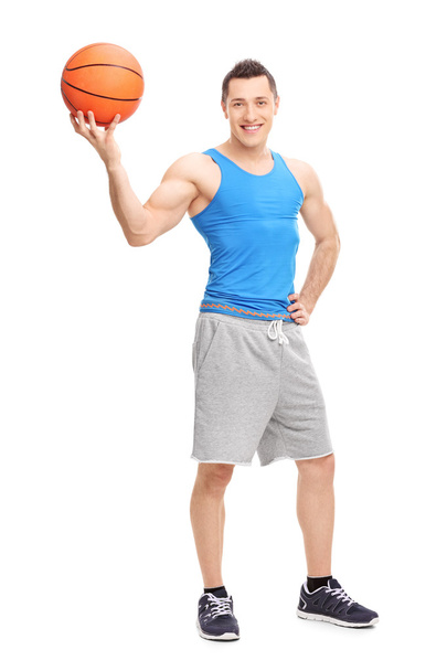 Handsome man posing with a basketball - Фото, изображение