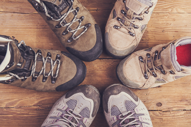 Hiking shoes on a wooden floor - Foto, afbeelding