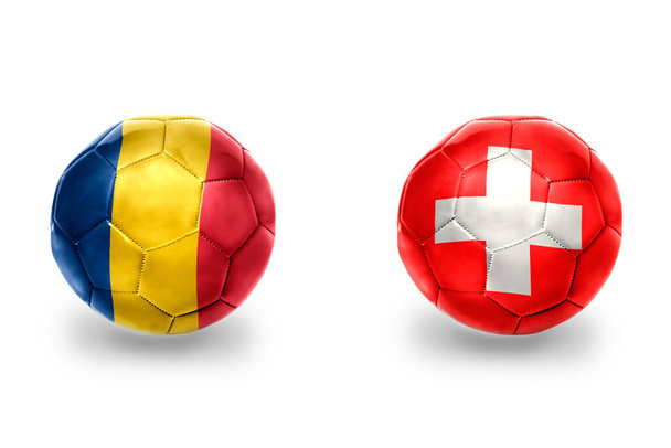 realisztikus focilabda nemzeti zászlókkal Svájcban és Romániában, focicsapatok. a fehér háttér. - Fotó, kép