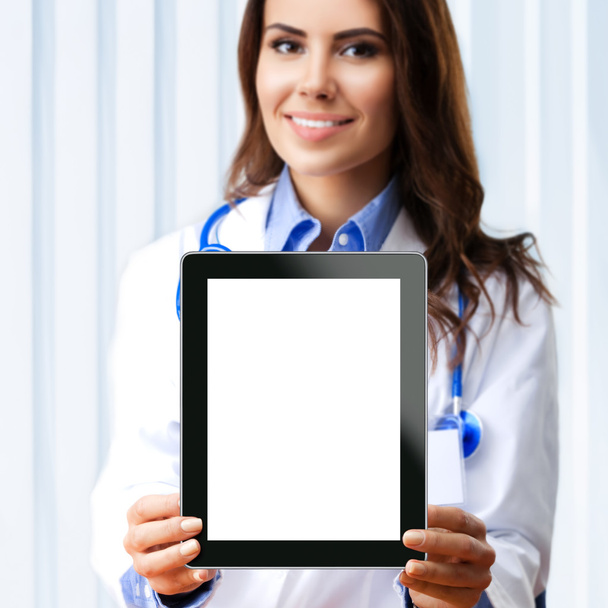 Female doctor showing blank tablet pc for copyspace - 写真・画像