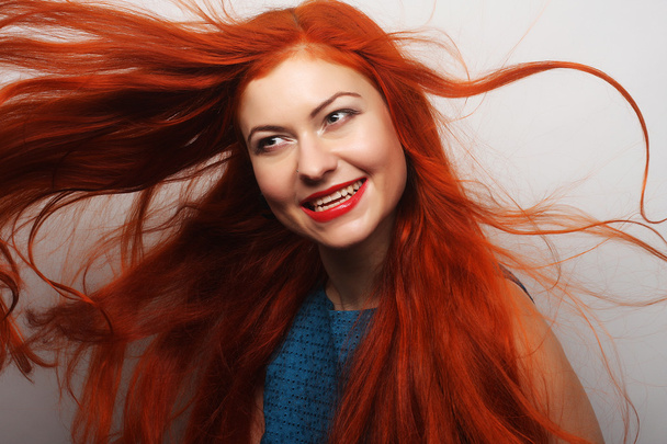 happy woman with long flowing red hair - Zdjęcie, obraz