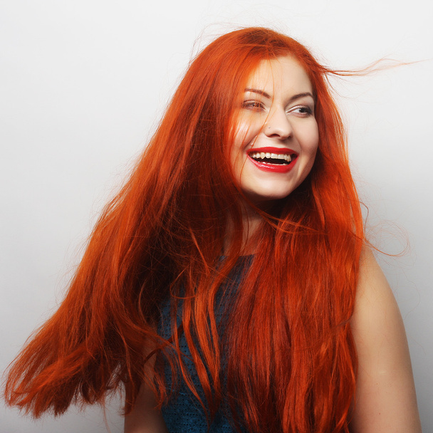 happy woman with long flowing red hair - 写真・画像