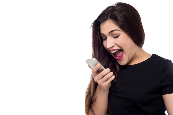 Woman screaming on a cell phone - Photo, Image