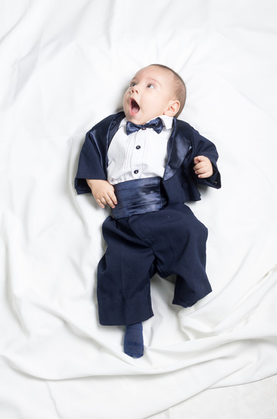 Cute baby boy wearing an elegant suit with bow tie - Valokuva, kuva