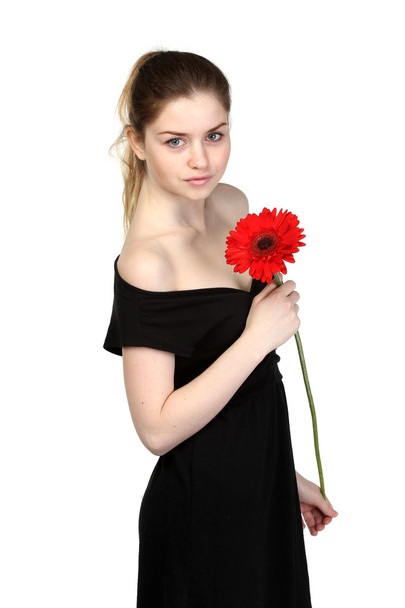 Beautiful girl with flower in black dress - Фото, зображення