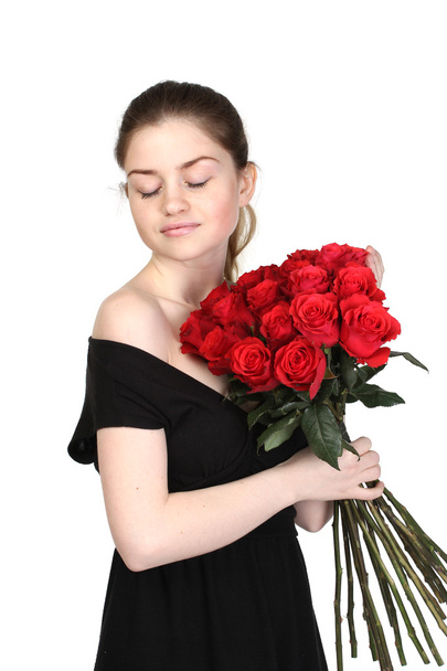 Beautiful brunette with a bouquet of roses - Φωτογραφία, εικόνα