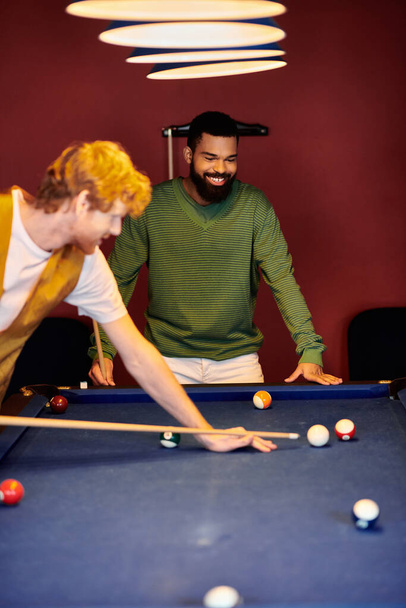 Friends enjoy a casual game of billiards in a stylish setting. - Photo, Image