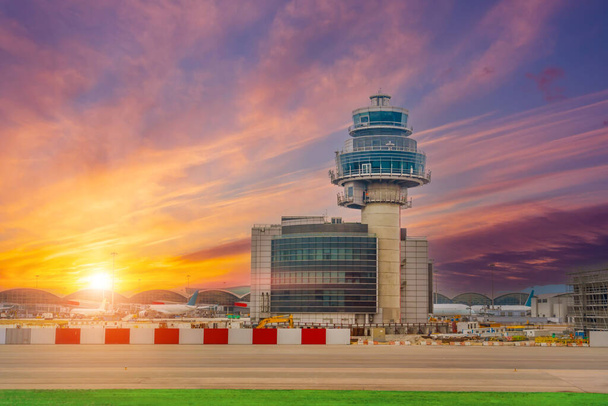 Torre de controle do aeroporto céu pitoresco nuvens saturadas brilhantes gradiente de fundo durante o pôr do sol - Foto, Imagem