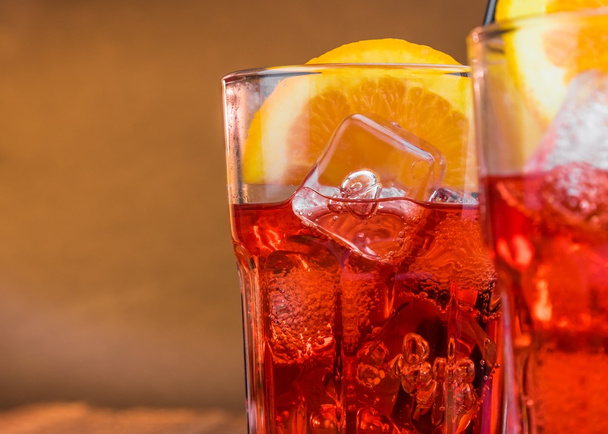 spritz aperitif aperol cocktail with two orange slices and ice cubes with space for text - 写真・画像