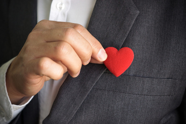 Businessman holds red heart - Foto, imagen