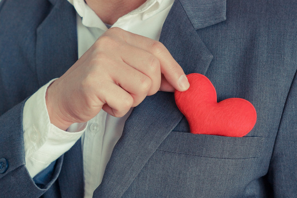 Businessman holds red heart - Foto, Imagen