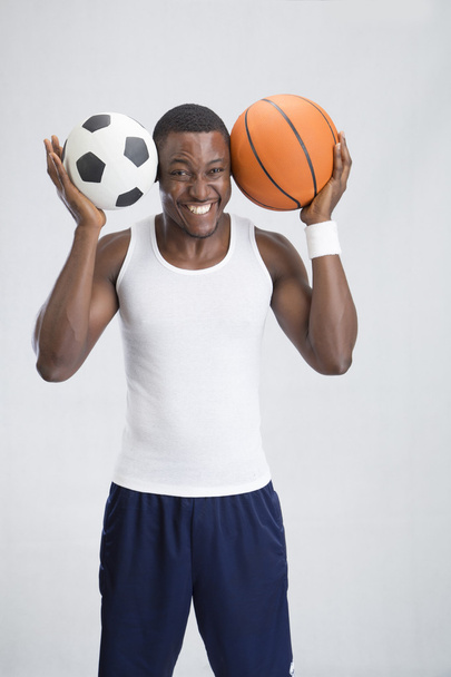 joven deportista con pelotas de fútbol y baloncesto
 - Foto, Imagen