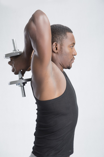 young sportsman lifting dumbbell - Photo, Image