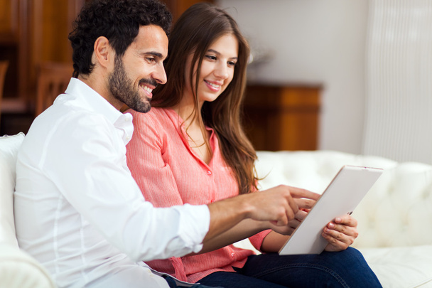 Happy couple using a tablet - Фото, изображение