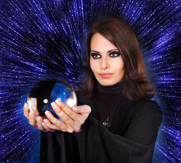 Girl with fortune telling ball against star sky. - Photo, Image