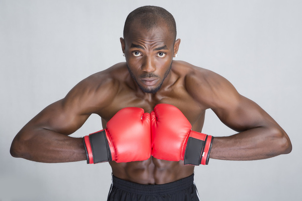 Young man in red boxing gloves - Photo, Image