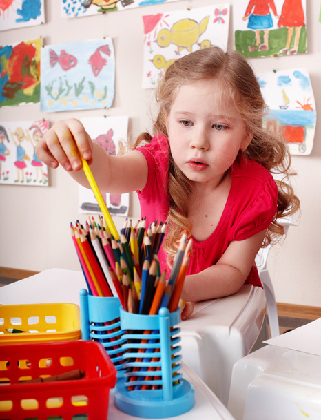 Child with colour pencil in preschool. - Photo, Image