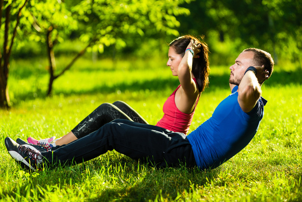 Couple exercising at the city park. Outdoor sport - Foto, imagen