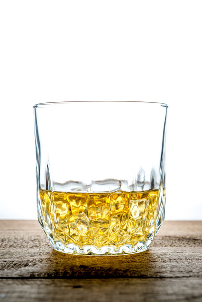 Whiskey glass with ice cubes on wooden - Φωτογραφία, εικόνα