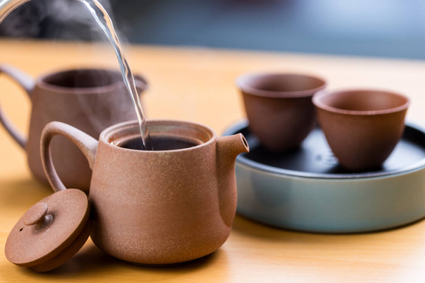 Hot water pour into tea pot - Photo, Image