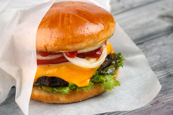 cheeseburger wrapped in paper - Photo, Image