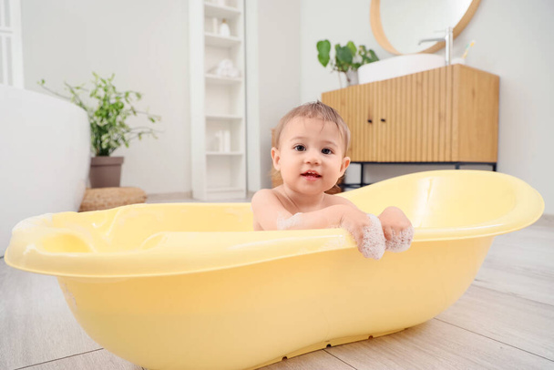 Little baby with foam in bathtub at home - Photo, Image