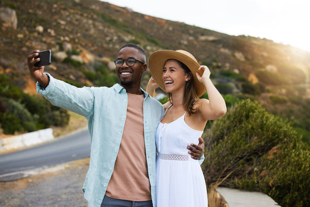 Road trip, interracial couple and smile for selfie in nature, travel or countryside for vacation in Brazil. Love, people and happy with social media for picture for holiday, journey or drive together. - Photo, Image
